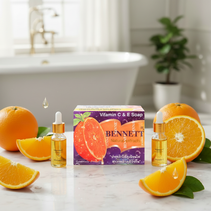 BENNETT Vitamin C & E Soap displayed on a marble bathroom surface with fresh oranges and green leaves
